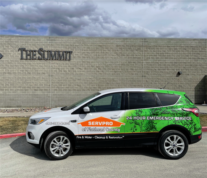 a SERVPRO vehicle parked in front of a business